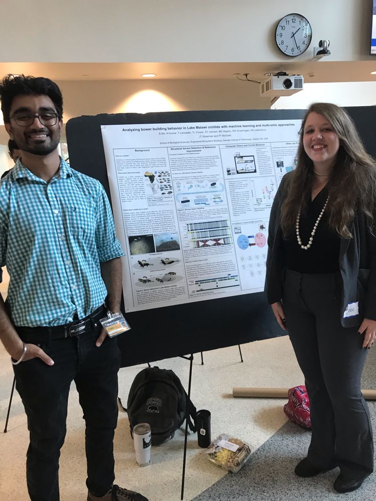 Bree and another student standing in front of their poster