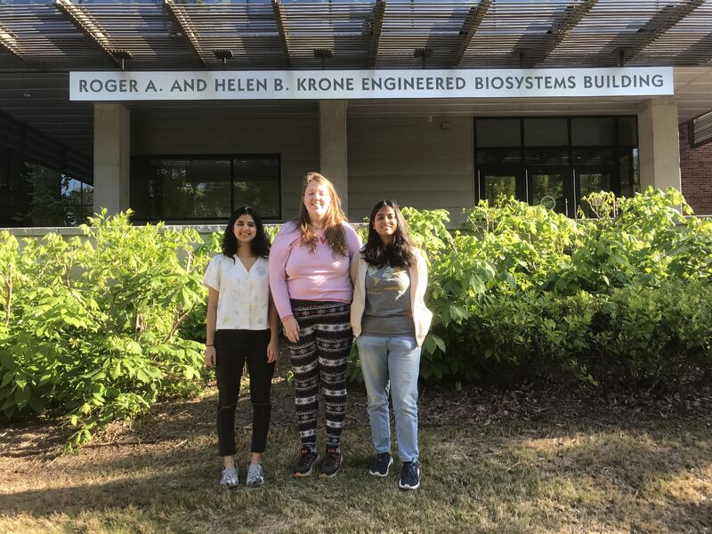 Asmiti Lagwanka, Breeana Shi, and Harini Mudradi standing in front of the Engineered Biosystems building